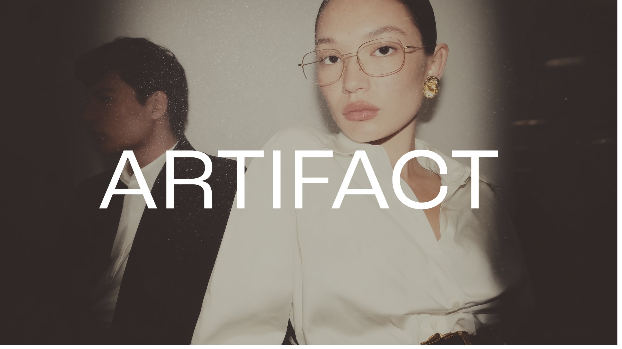 Person wearing glasses with the word 'ARTIFACT' overlayed
